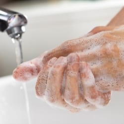 Washing resin off hands with soap and water.